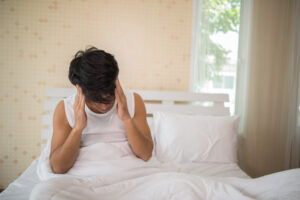 Person waking up feeling tired after sleep